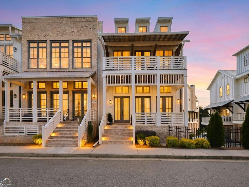 The illuminated exterior of the Parkstead Lane townhome at dusk