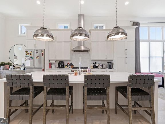 Kitchen island with pendant lights and seating